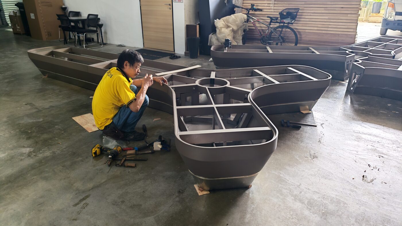 Laser Welding Stainless Steel and Aluminium: Low-Distortion Seams for Finish-Critical Work Fabricated metal units being assembled and dressed on the workshop floor before finishing.