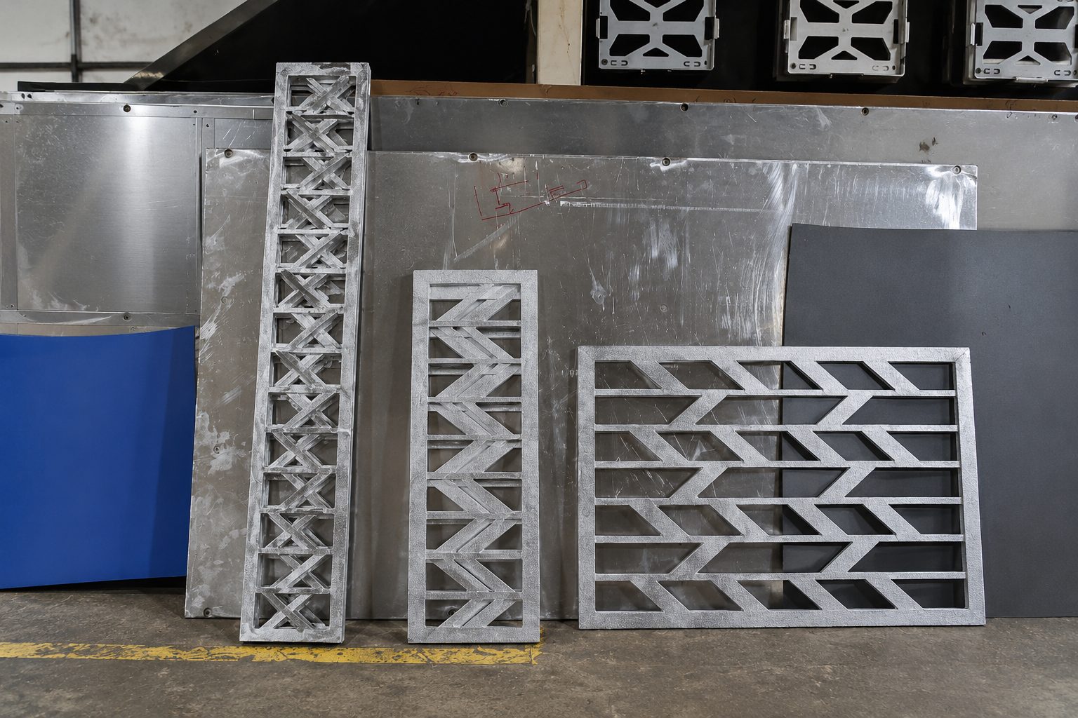Profiled aluminium components produced in the Rongda Pacific workshop, showing several different cut patterns.