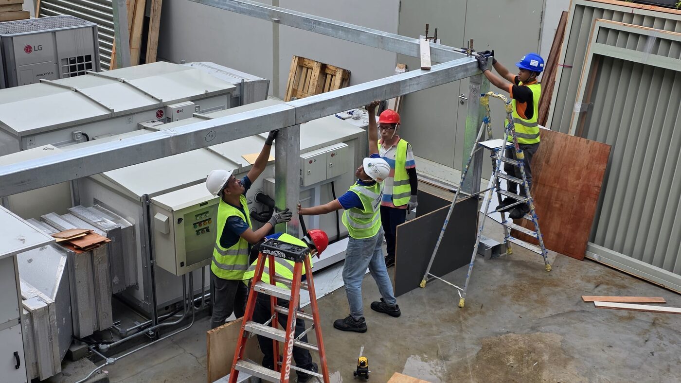 A Rongda Pacific site team setting out and installing a fabricated steel frame in full personal protective equipment.