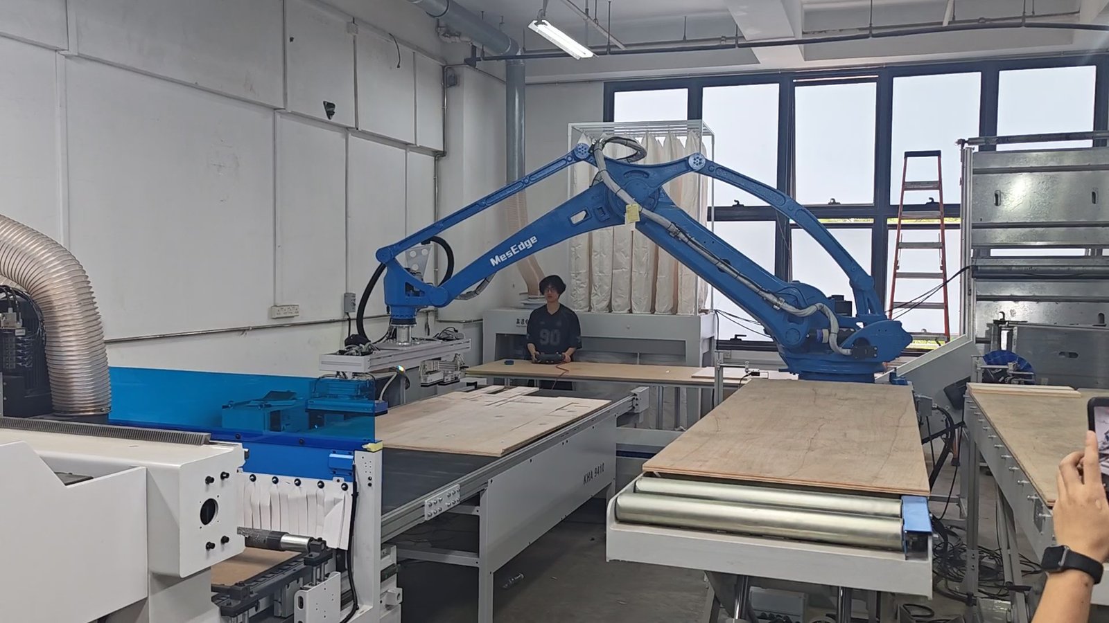ENF, E0 and E1 Plywood: What the Formaldehyde Grades Actually Mean Panel handling in a joinery workshop, with sheet material stacked beside a nesting machine.
