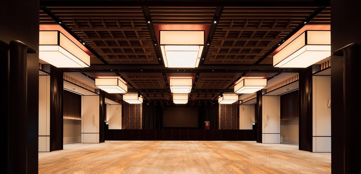 Timber-finished operable partition panels installed across a large function room