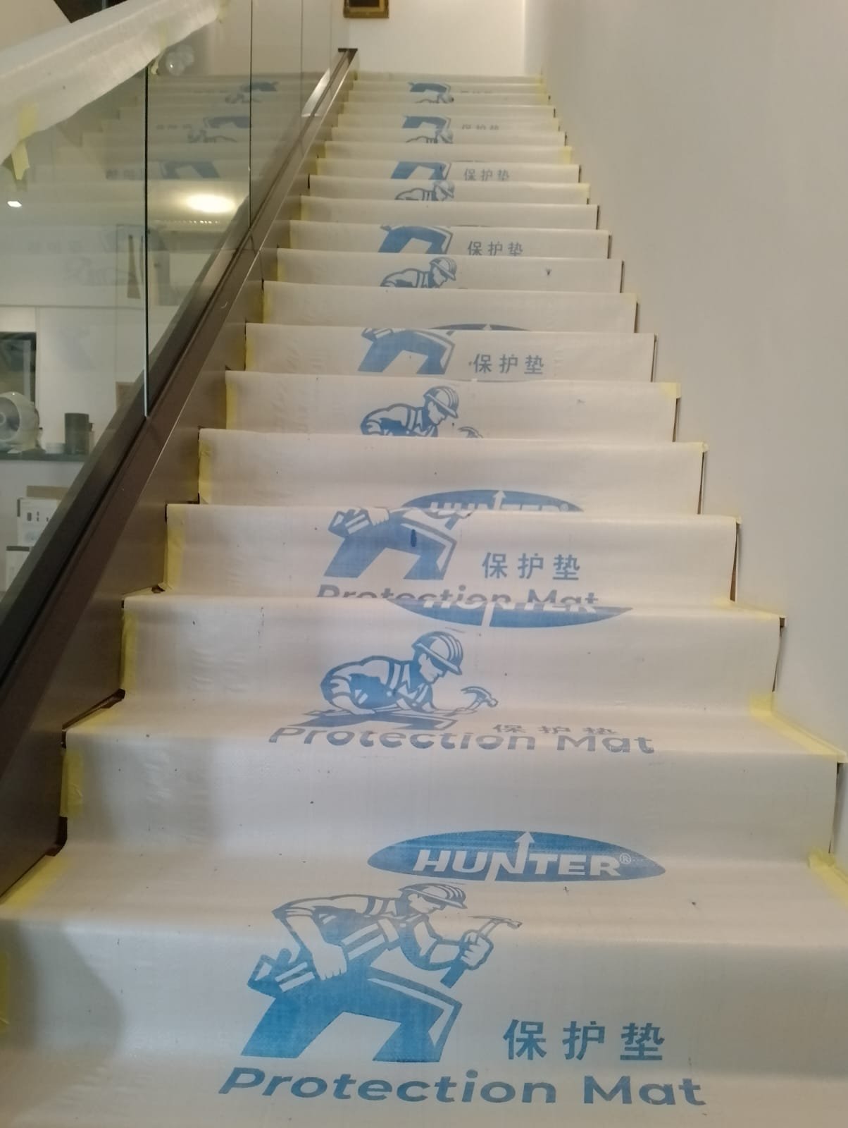 A&A Contractor in Singapore Staircase covered with protection matting during works in an occupied building