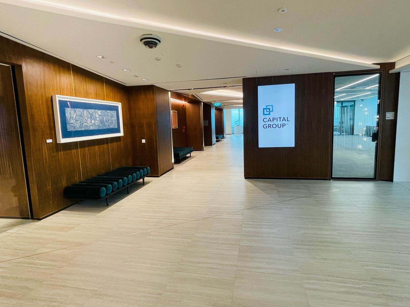 Office lobby finished in timber veneer panelling with a stone floor