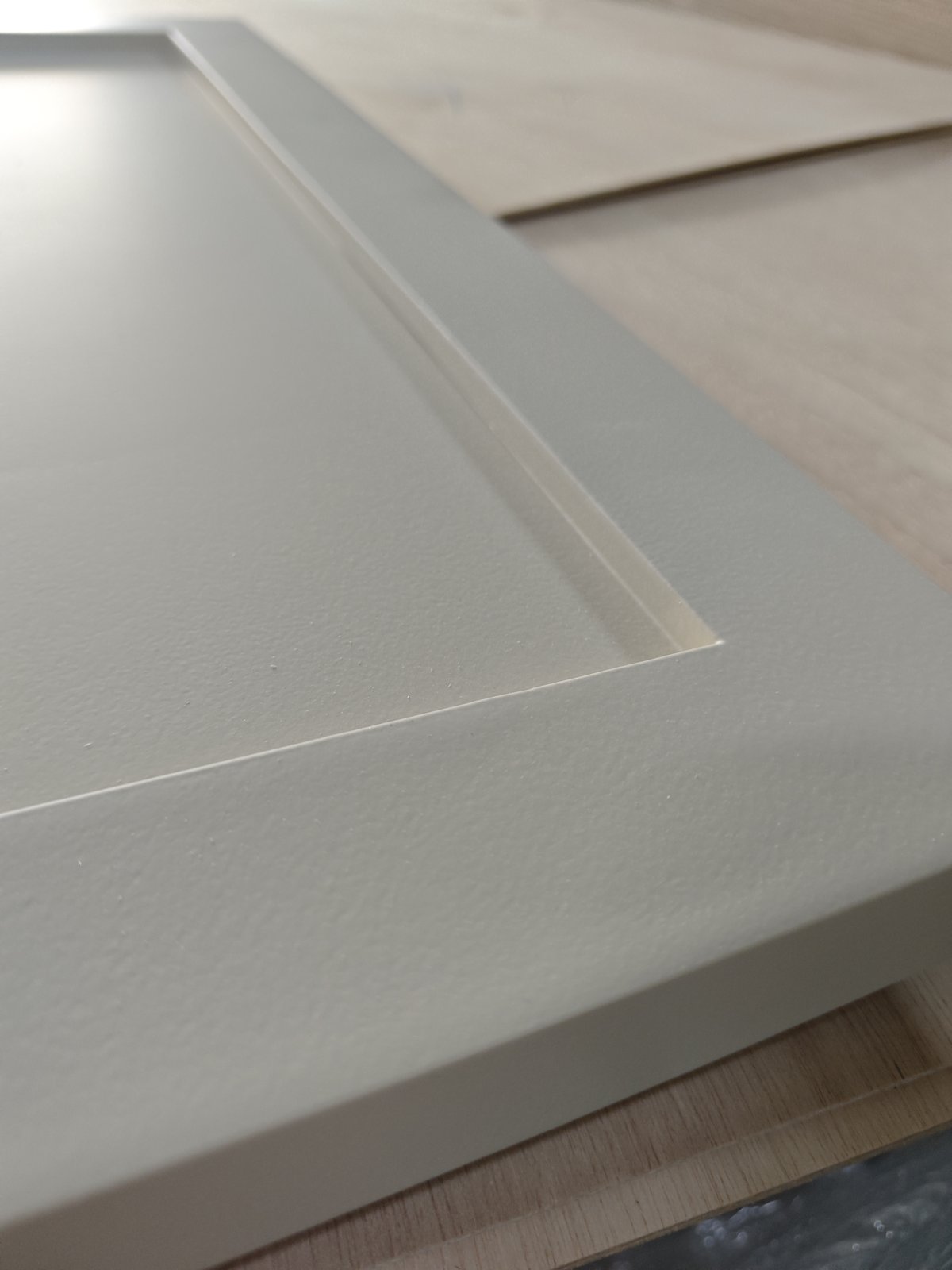 Custom Carpentry & Joinery in Singapore Close-up of a sprayed panel edge showing the finished profile