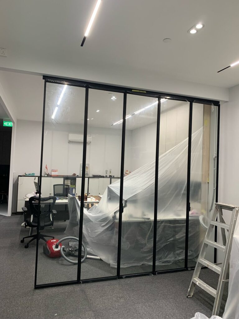Dust, Noise and Smell Control for Works in a Live Building Workstations covered in protective sheeting behind a glazed partition in a live office