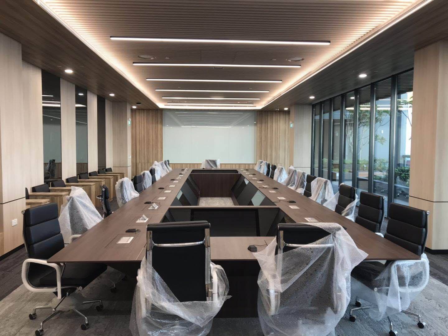 FF&E Installation Services in Singapore Installed boardroom chairs wrapped in protective film ahead of handover