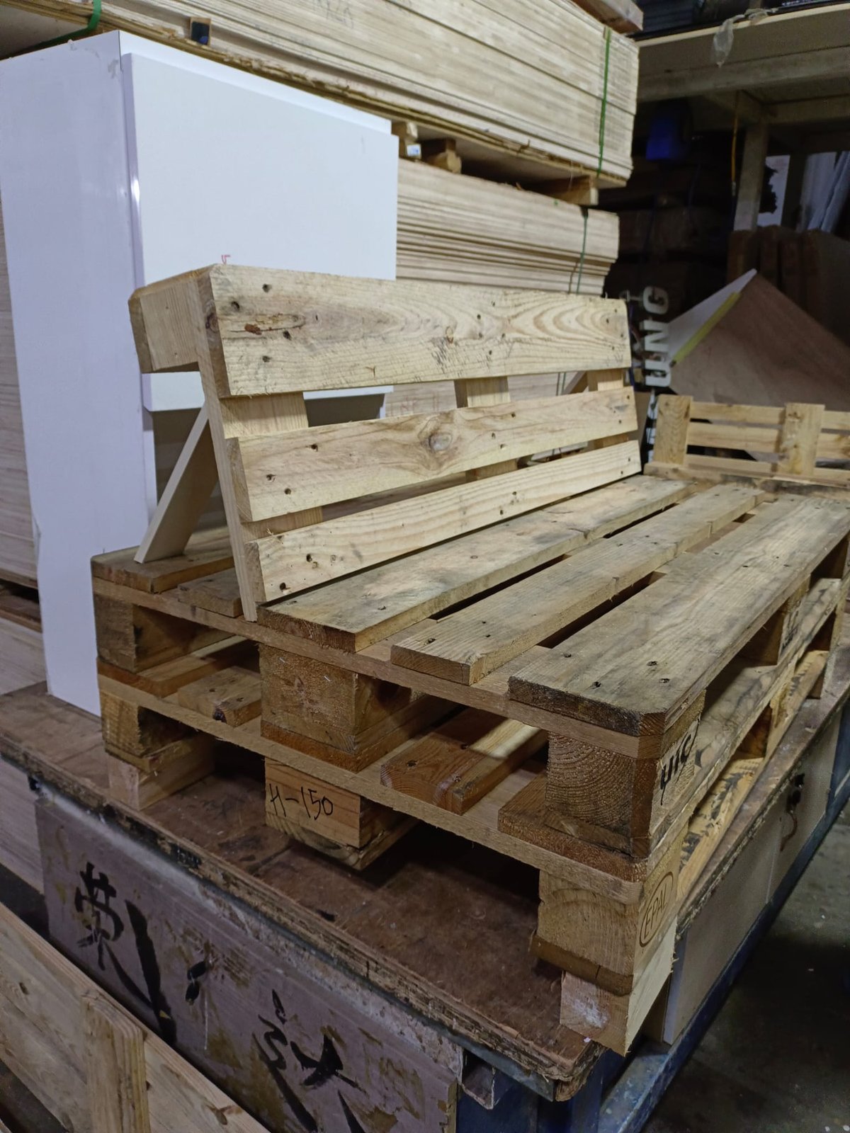 FF&E Installation Services in Singapore Timber pallets and shipping crates staged in a receiving area before FF&E installation
