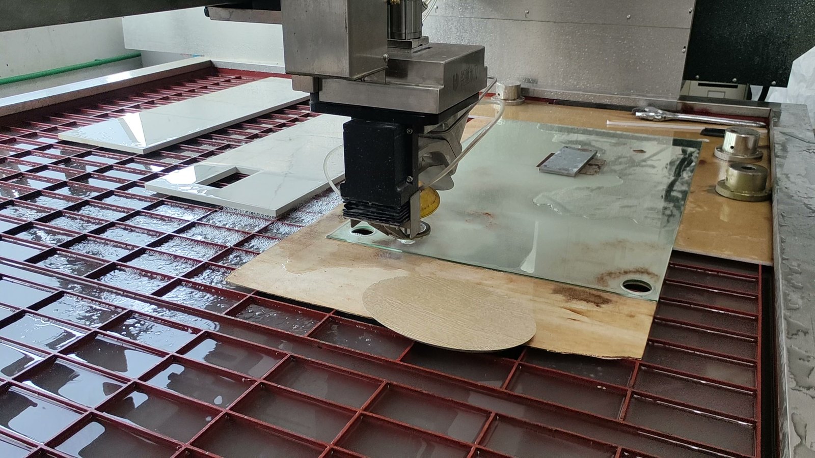 Metal Fabrication in Singapore Waterjet cutting a sintered stone slab on the machine bed in our facility