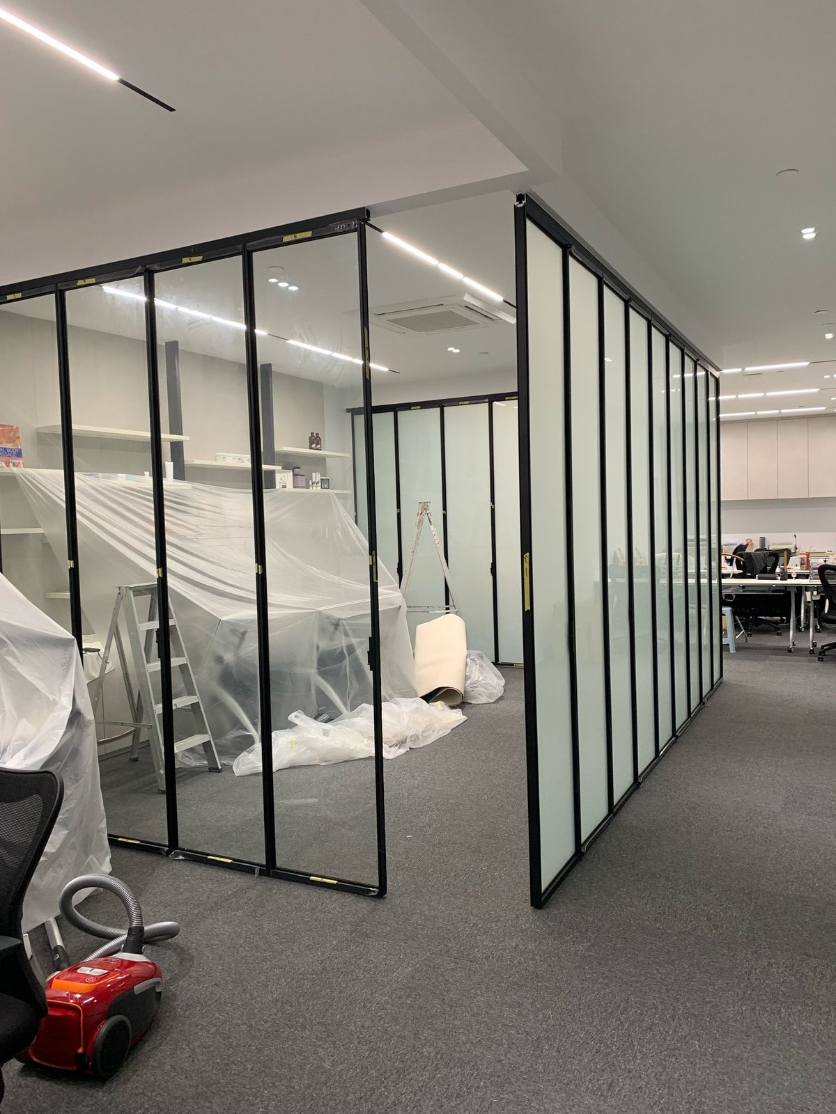From CAD File to Installed Metalwork: How a Fabrication Job Actually Runs Slim metal-framed glazed partitions being installed in an occupied office