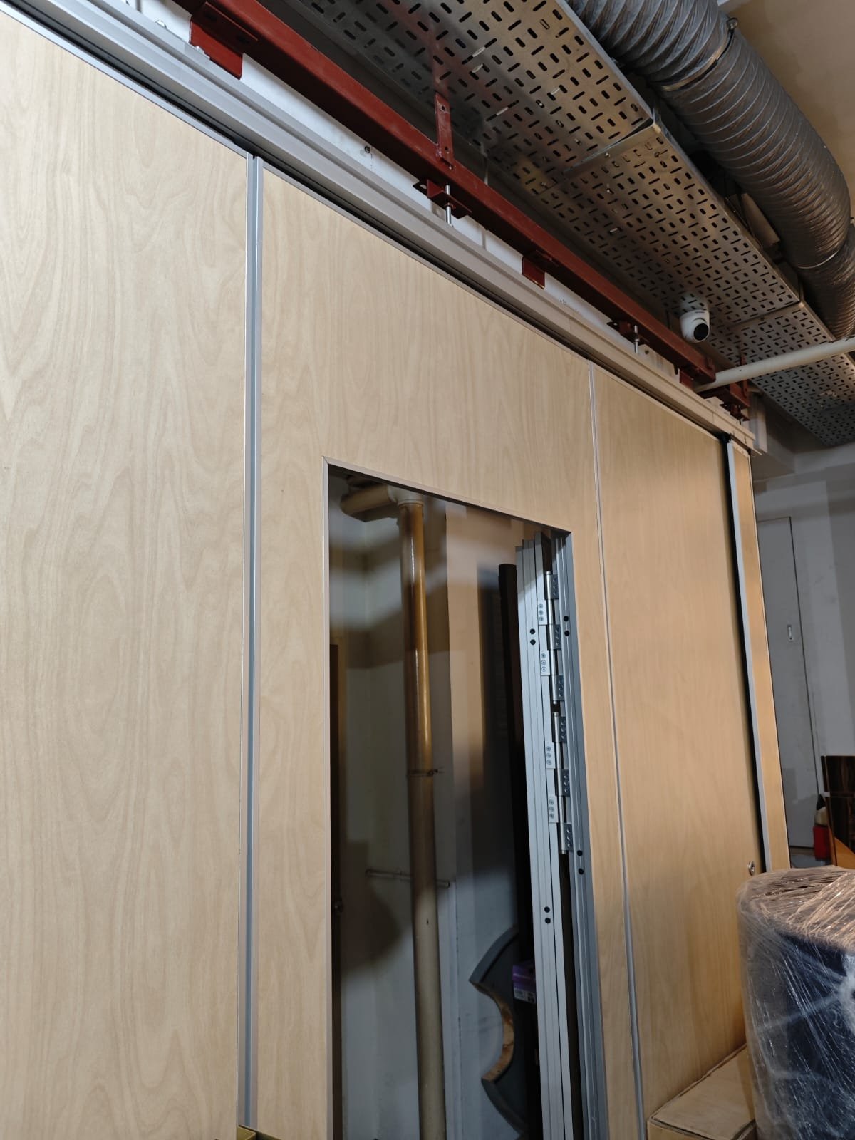 Operable Walls & Acoustic Partitions in Singapore Operable wall panels installed with the overhead track and building services above