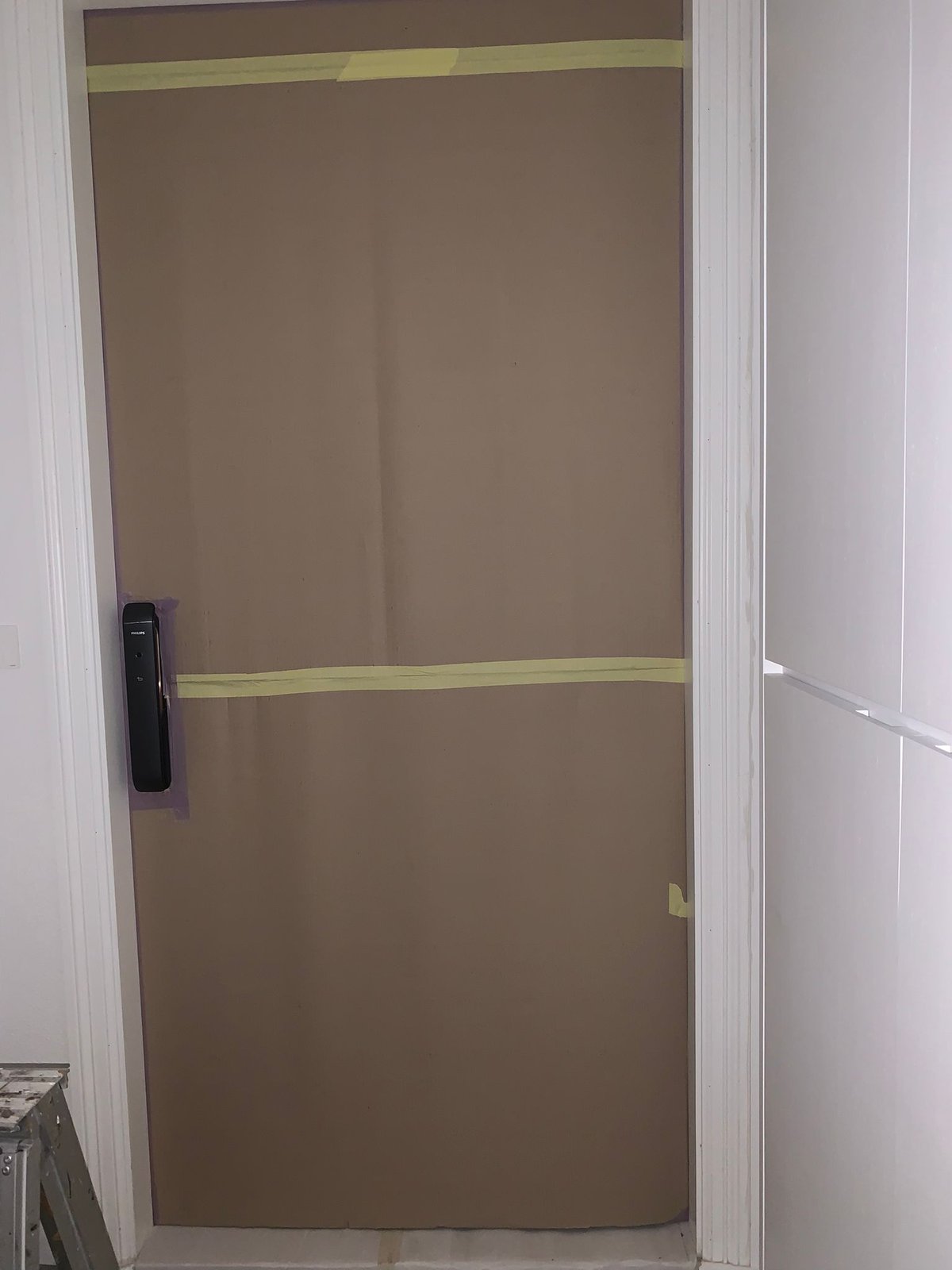Dust, Noise and Smell Control for Works in a Live Building Completed door leaf covered and taped to protect it during ongoing works