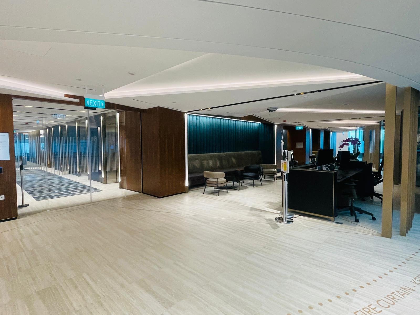 Green Mark Fit-Out for Landlords and Developers in Singapore Completed office corridor in Singapore with a timber slat ceiling and recessed linear lighting