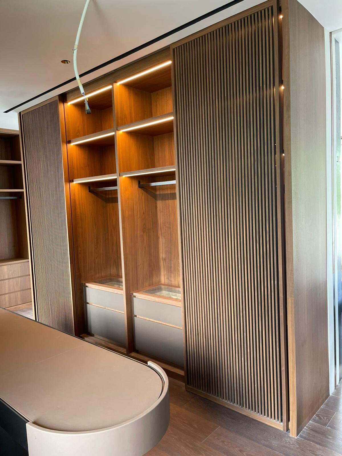 High-Level & Oversized Imported Furniture Installation in Singapore: Access, Lifting, Temporary Support and Safe Fixing curved fluted joinery full height installation singapore