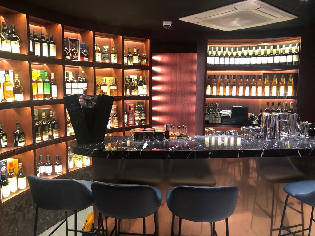 Integrated Glass, Aluminium & Metal Components in Imported Furniture: Why Luxury FF&E Needs Multi-Trade Installation Coordination in Singapore backlit glass and metal display wall with stone counter singapore