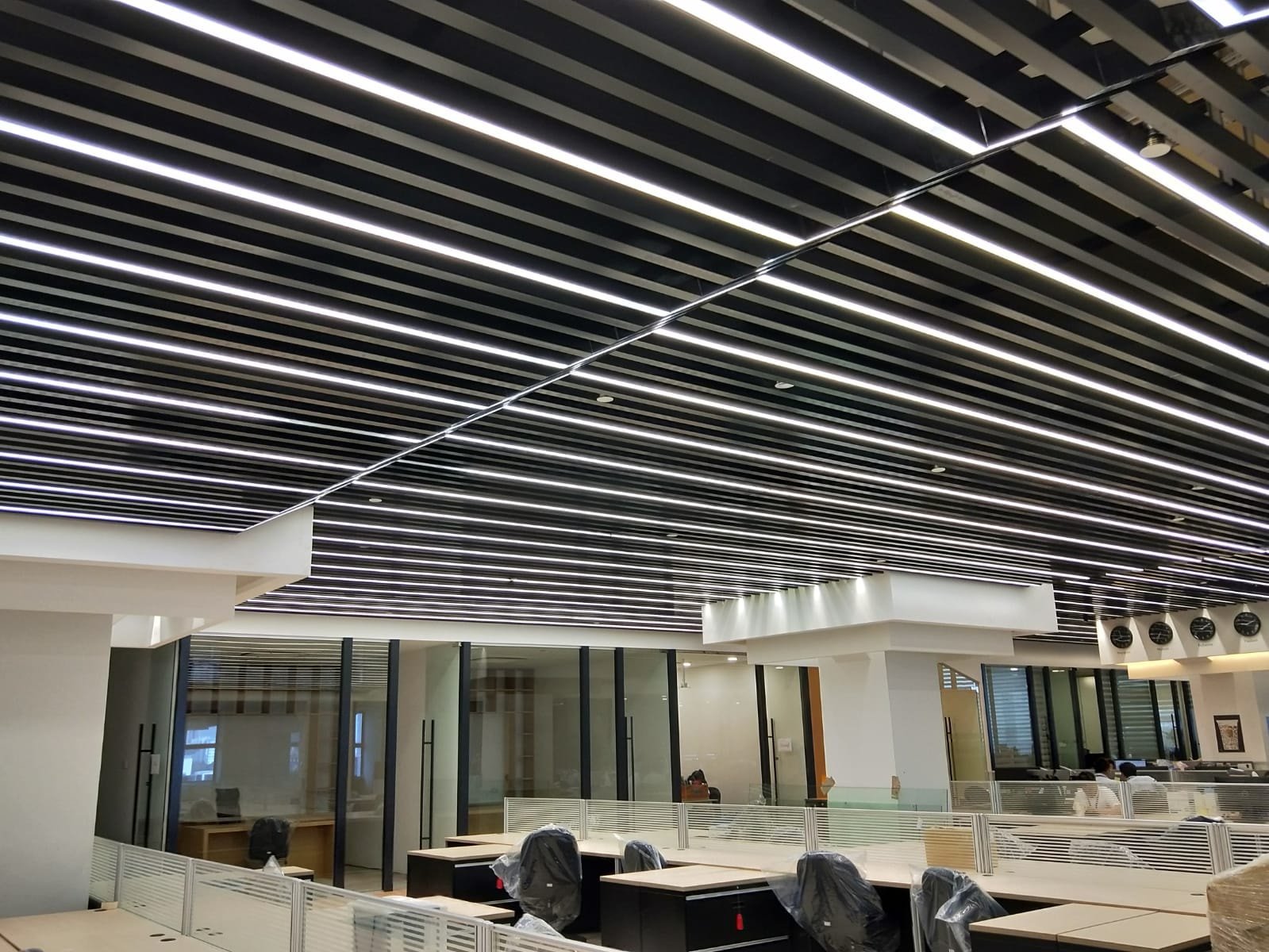 Commercial Renovation Cost in Singapore: Where Does the Money Actually Go? linear ceiling and services above an open plan office singapore