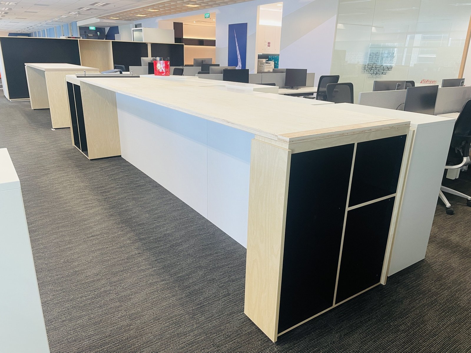 How Long Does an Office Renovation Take in Singapore? Programme, Critical Path and the Last Ten Per Cent long fitted counter run in an open plan office singapore