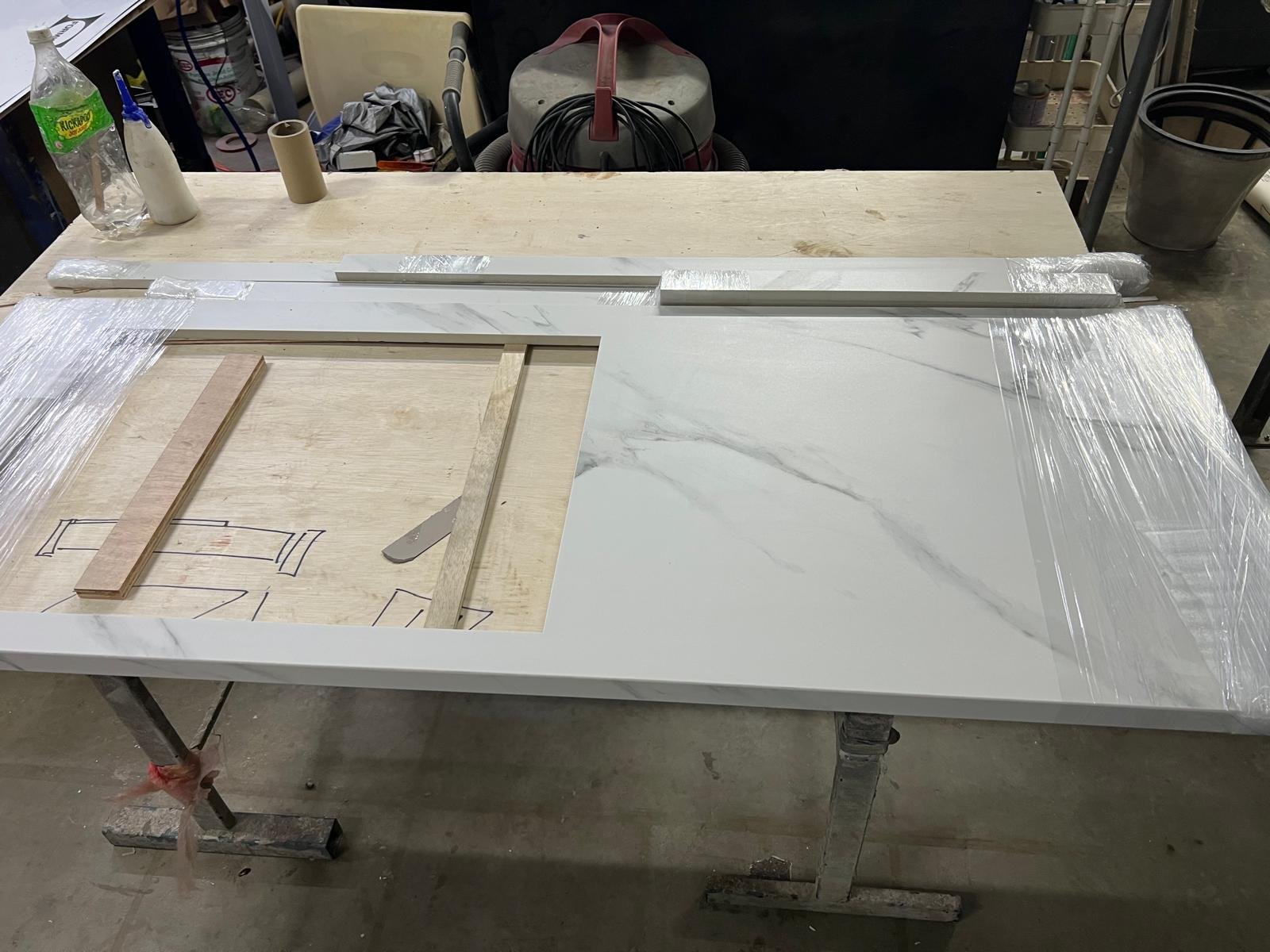 Metal Fabrication in Singapore Sintered stone slab on the fabrication bench with cutting template and clamps