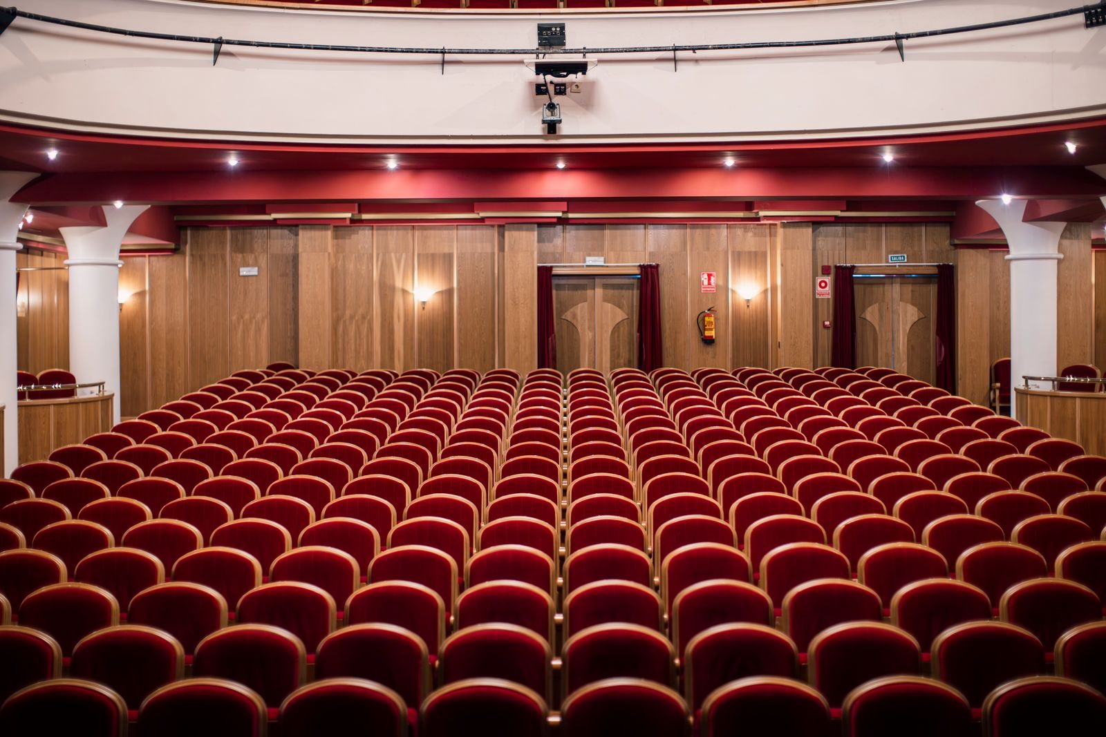 Acoustic Panels for Theatres and Auditoriums in Singapore: What the Installation Has to Get Right Auditorium seen from the stage, with rows of red seats and a timber-panelled rear wall