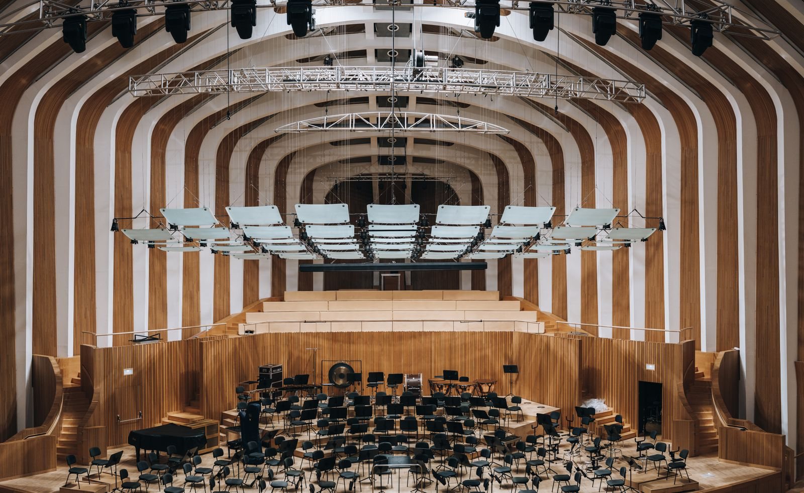 Acoustic Panels for Theatres and Auditoriums in Singapore: What the Installation Has to Get Right Concert hall with suspended reflector panels above the stage and timber-lined walls