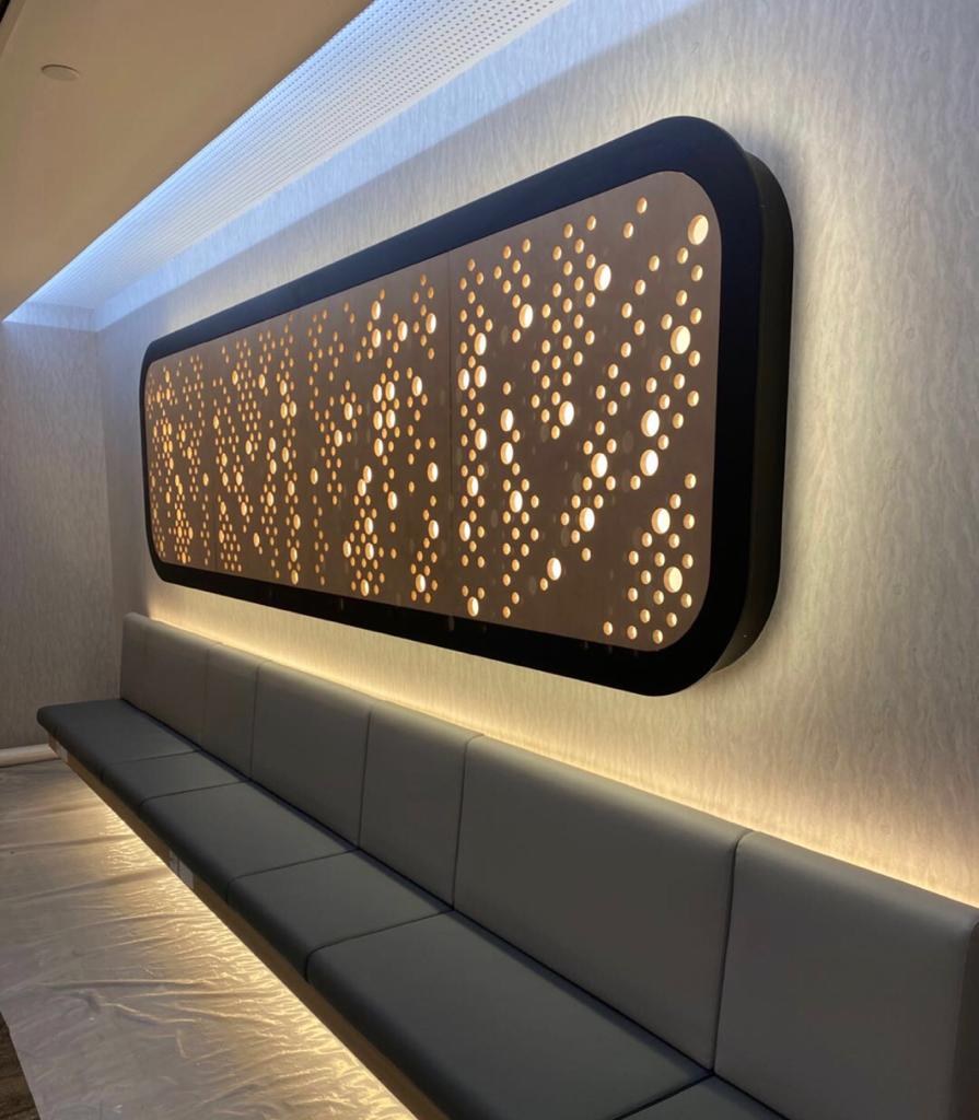 Acoustic Panel Subcontractor in Singapore: What Main Contractors and Developers Should Settle Before Award Perforated timber feature panel set into a wall above a built-in banquette in a Singapore office