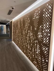 Acoustic Panel Subcontractor in Singapore: What Main Contractors and Developers Should Settle Before Award Perforated Timber Wall Office Corridor Singapore 228x300
