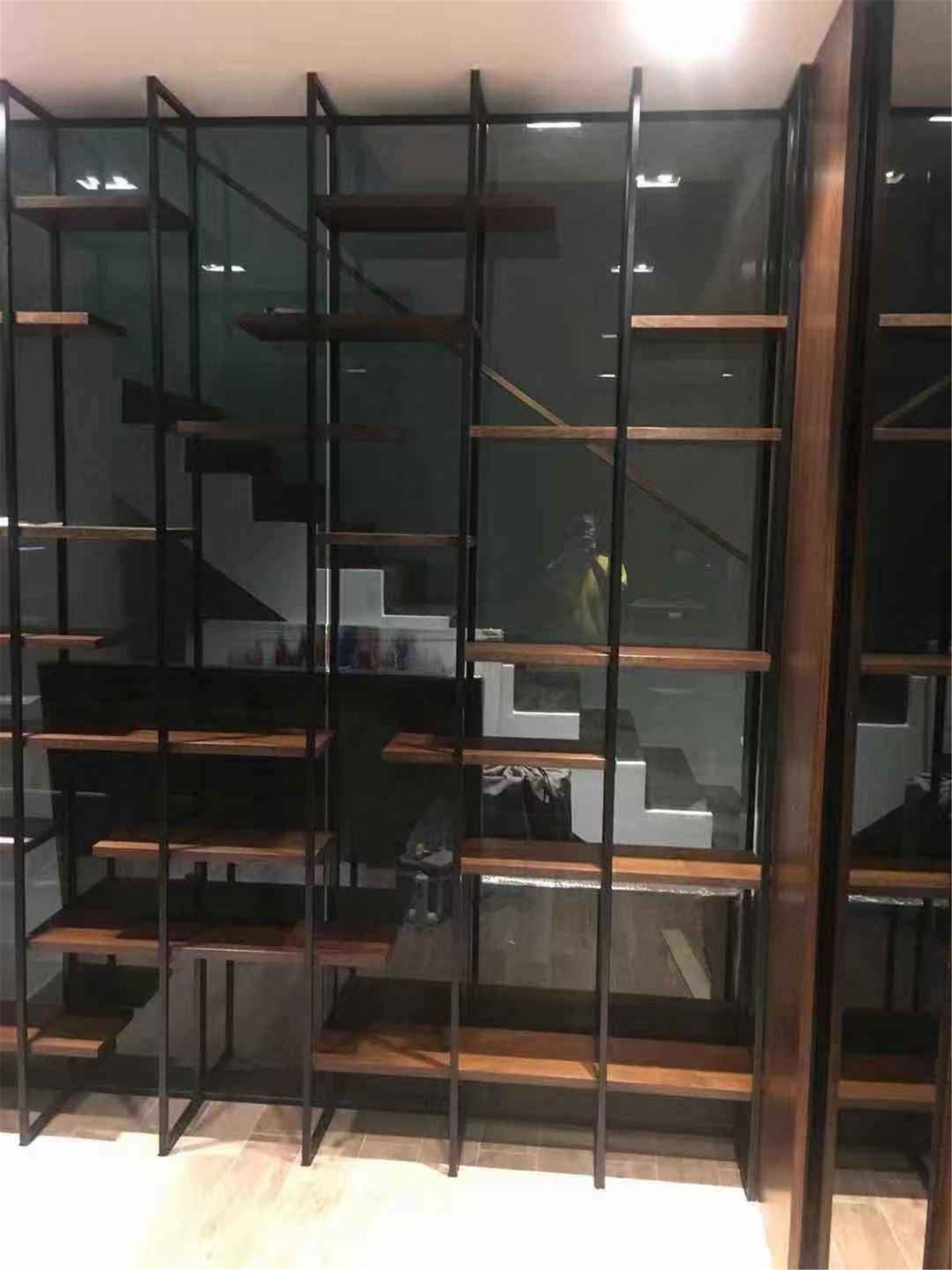 steel and timber display shelving dividing a completed Singapore interior